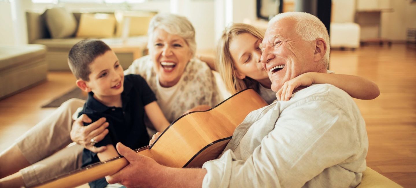 Close up of a grandfather and grandmother having a great time with grandchildren